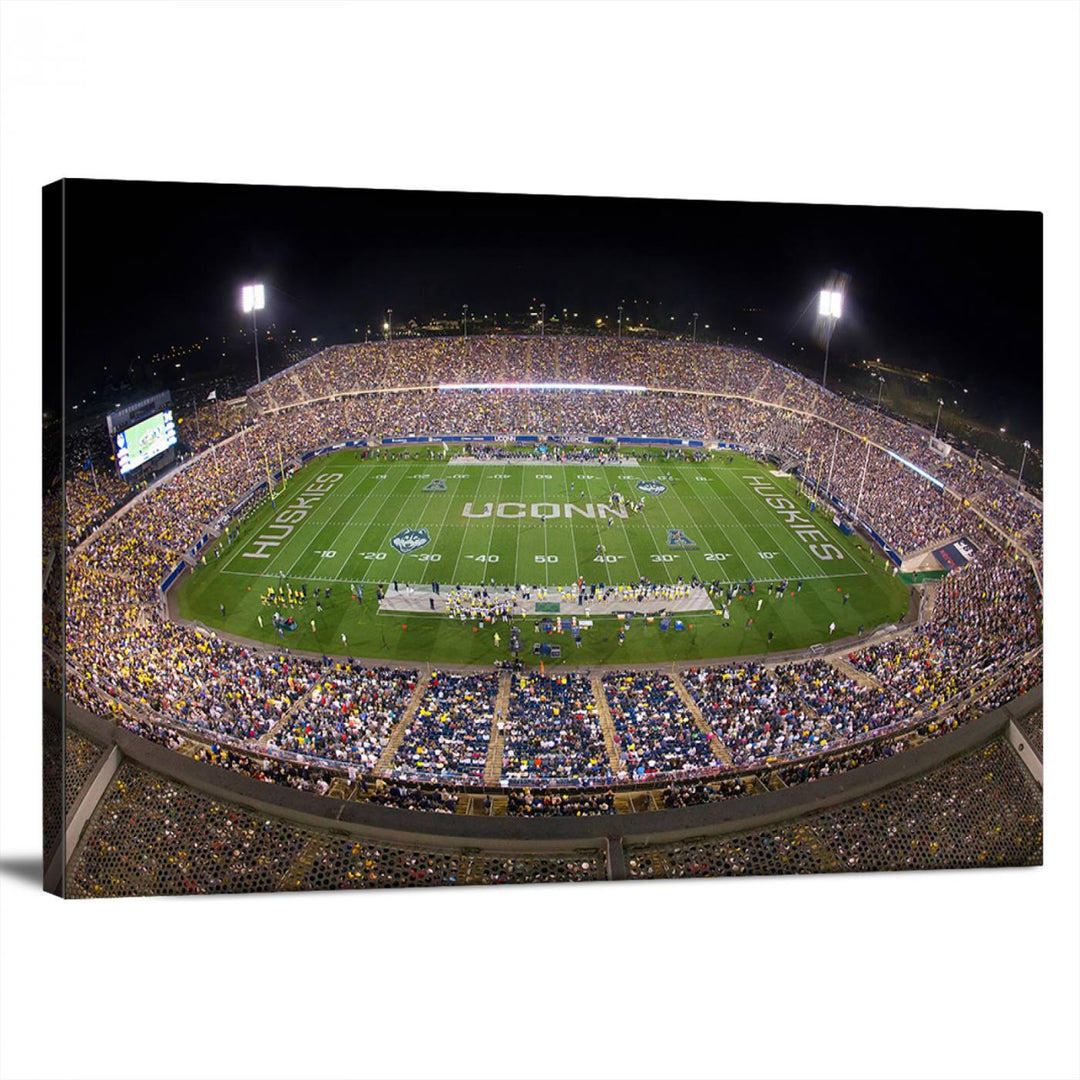 A large football stadium at night, featuring the UCONN Huskies, is depicted on the East Hartford Pratt & Whitney Stadium Wall Art Canvas Print.