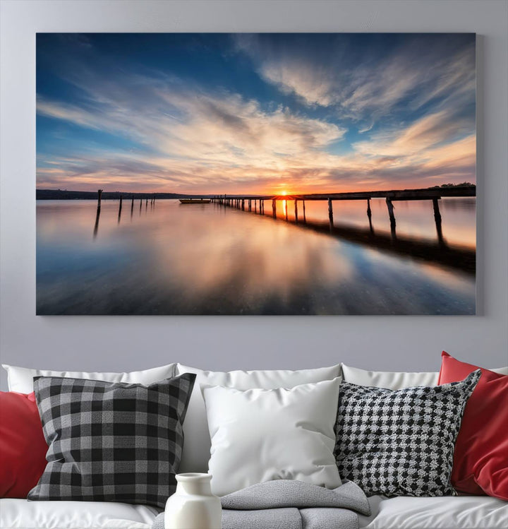 The Sunset Pier Canvas features a serene coastal landscape with vibrant hues under cloudy skies, ideal for modern decor.