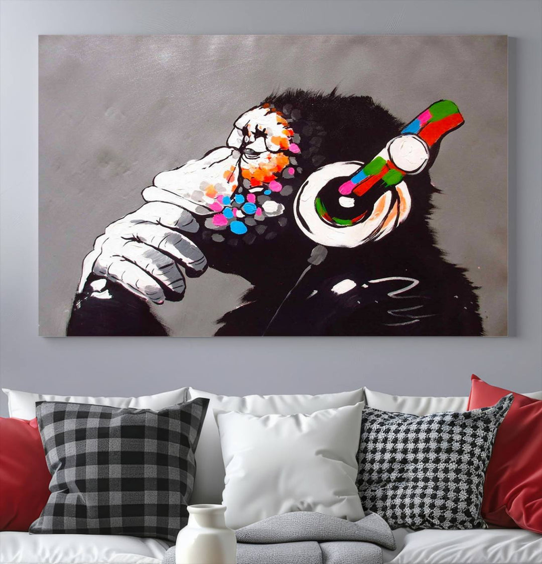 A vibrant triptych, the "DJ Monkey Listening to Music" wall art print, features a Banksy-inspired large canvas adorned with colorful modern pop art. This striking piece elegantly enhances the room with its dynamic and lively depiction.