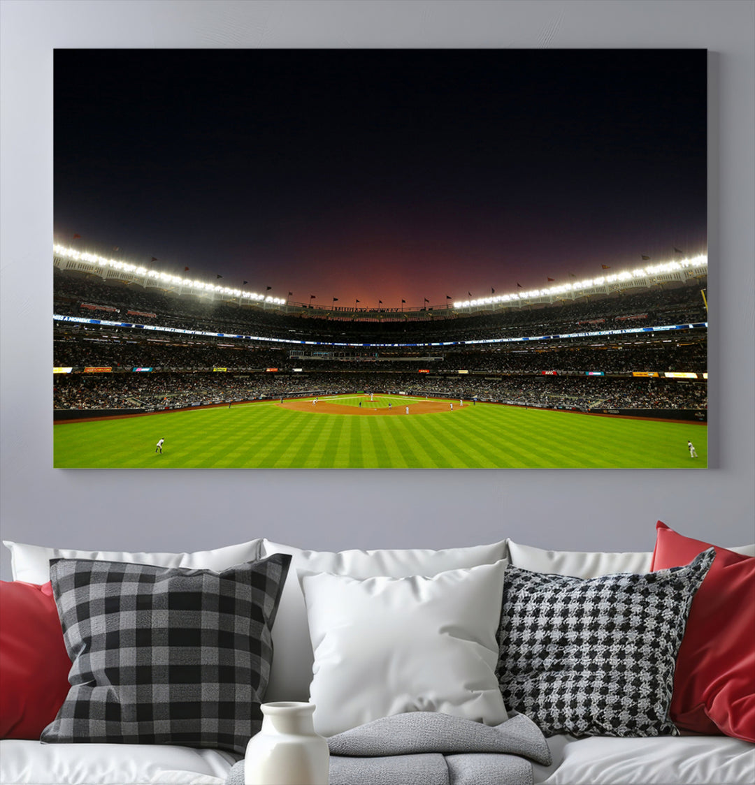 A night game at Yankee Stadium depicted on canvas beneath a sunset sky.