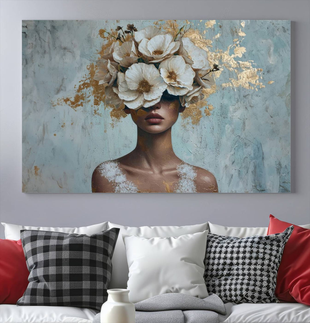 The Golden Petal Silhouette Woman Wall Art Canvas Print, a large 3-panel canvas with a textured gold floral design, serves as a luxurious centerpiece in modern glam settings. The artwork depicts a woman with flowers over her eyes against a textured background and hangs elegantly.