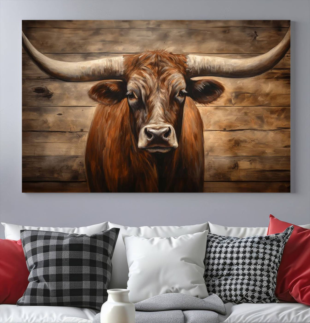 The Longhorn Bull Wall Art, a ready-to-hang canvas print, showcases an image of a brown longhorn cow set against a wooden background, perfect for those looking to enhance their space with rustic farmhouse and western barn decor.