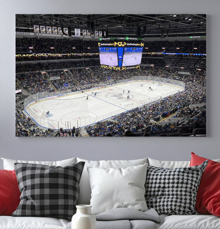 A large Enterprise Center canvas of a crowded hockey arena hangs prominently.