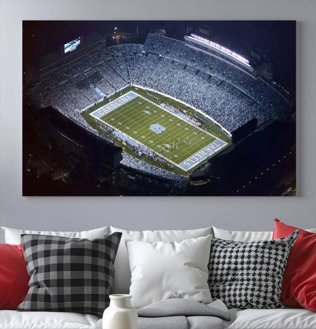 A University of North Carolina Tar Heels Football Team Print, showcasing Chapel Hill's Kenan Memorial Stadium, hangs in a modern dining room, adding a gallery-quality finish that enhances the entire space.