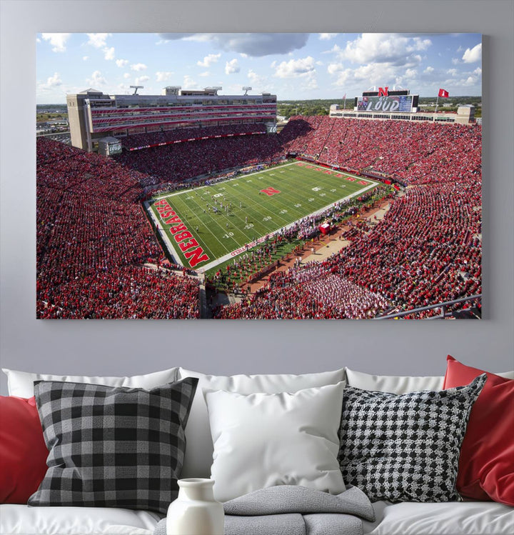 The University of Nebraska Cornhuskers Football Team Print showcases a vibrant triptych of Lincoln Memorial Stadium, depicting a packed football stadium filled with energetic fans. This handmade art piece is crafted in the USA and printed on premium canvas for a gallery-quality finish.