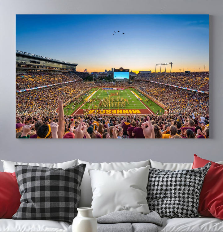 Canvas wall art featuring the University of Minnesota Football Team print, showcasing Huntington Bank Stadium at sunset with jets overhead.