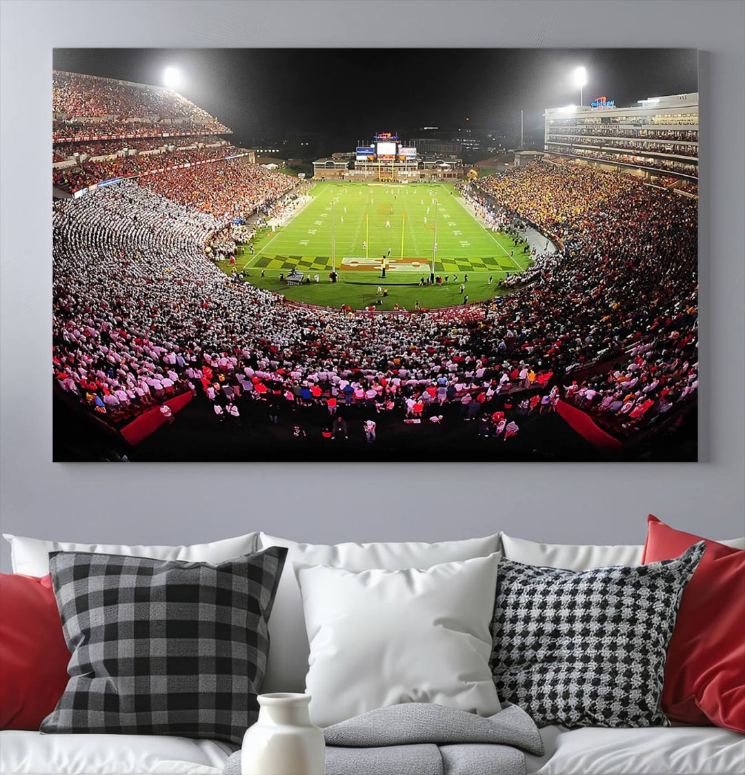 The Maryland Terrapins Football Wall Art Canvas showcases a packed SECU Stadium at night with a bright field and cheering fans.