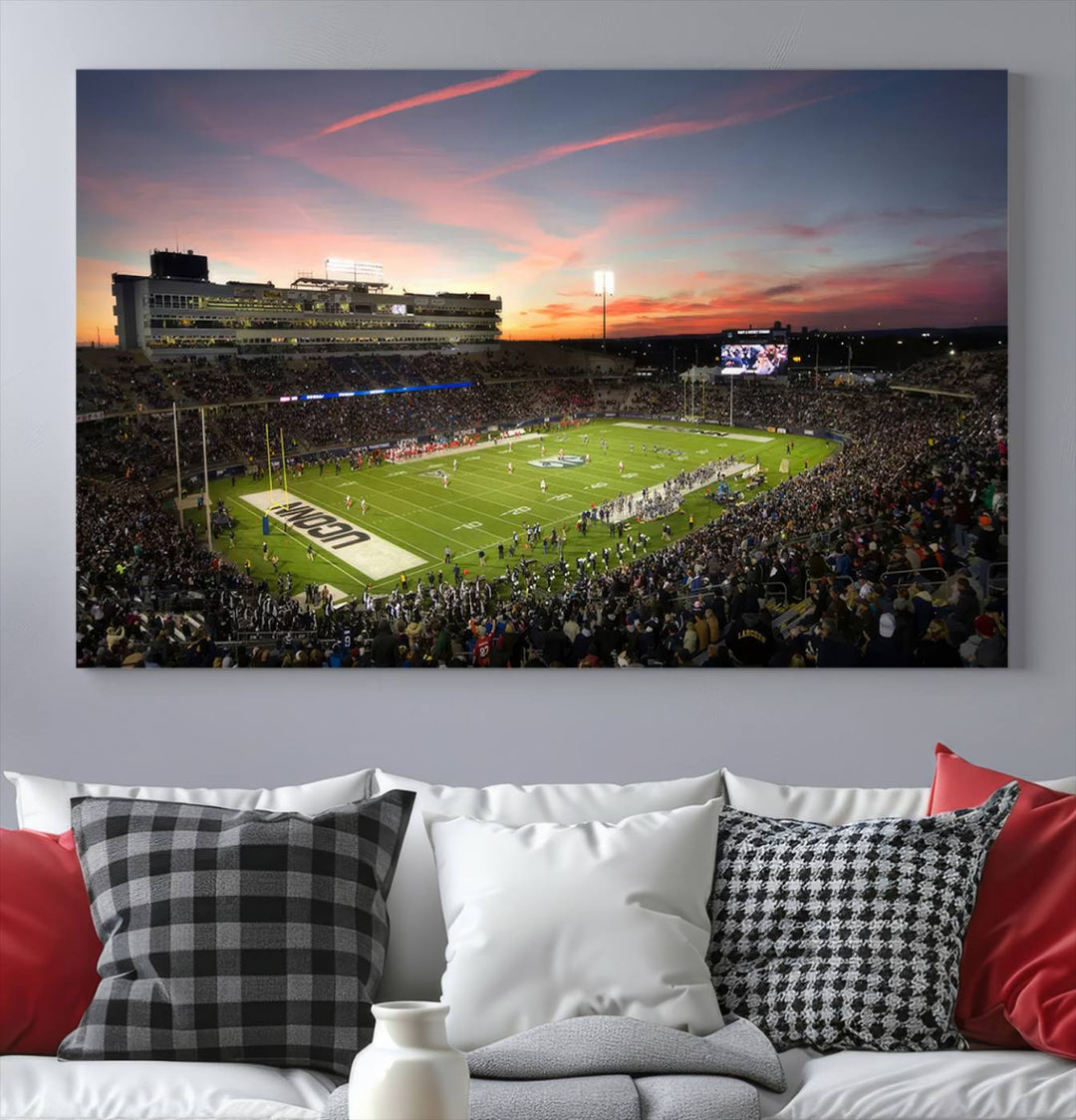 This wall art canvas print captures UCONN Huskies fans energizing a sunset scene at East Hartfords Pratt & Whitney Stadium.