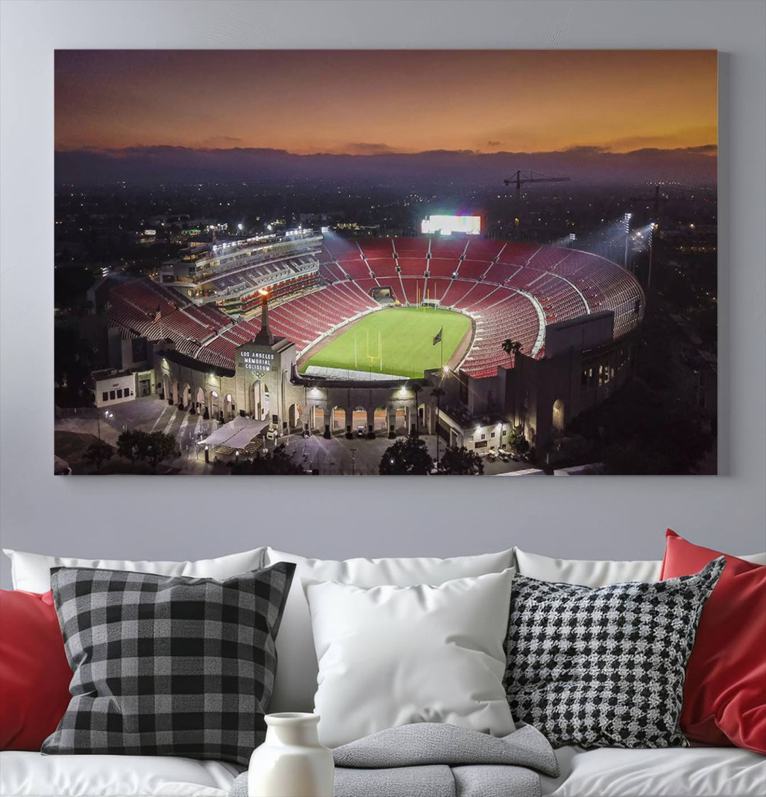 The USC Trojans Stadium canvas captures Memorial Coliseum at twilight, showcasing red seats and a green field beneath an orange sky.