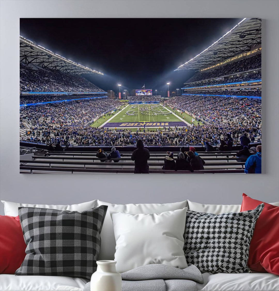 A canvas print titled The University of Washington Huskies Football depicts a packed Husky Stadium at night, as seen from the stands.