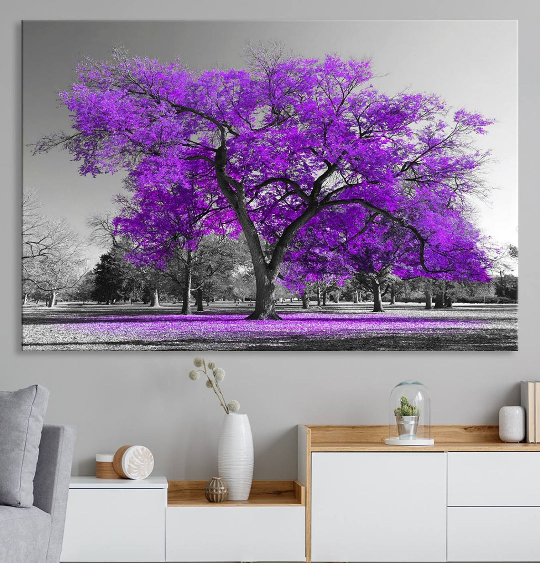 The Big Purple Tree Wall Art Canvas Print showcases a vibrant purple tree set against a black-and-white landscape.