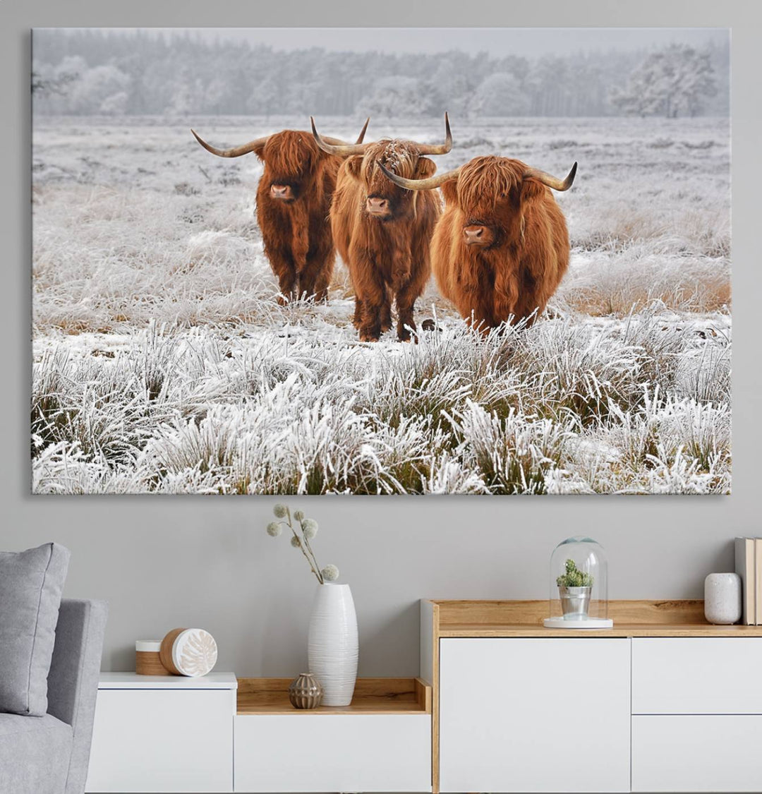 The Highland Cows in Snow canvas showcases three cattle in a frosty field.