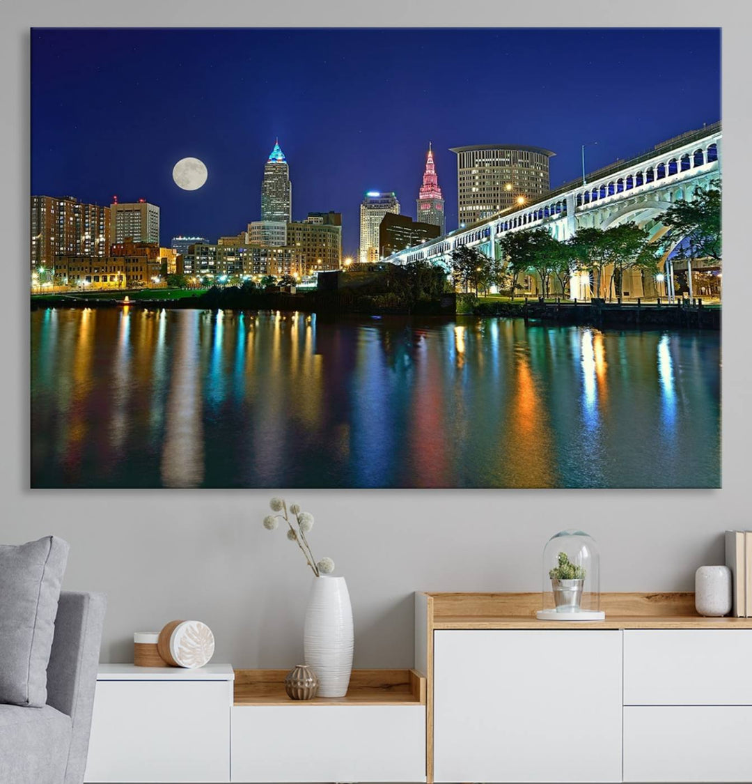 Cleveland City Lights Night Skyline Wall Art canvas showcases a moonlit cityscape reflected on water.