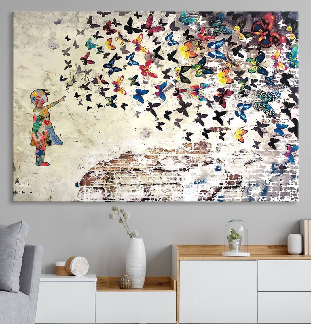 A Banksy Girl Butterfly Canvas Print is displayed on the textured wall.