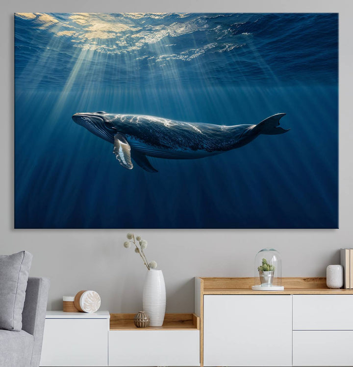 The Whale under Ocean wall art canvas print graces the white wall.