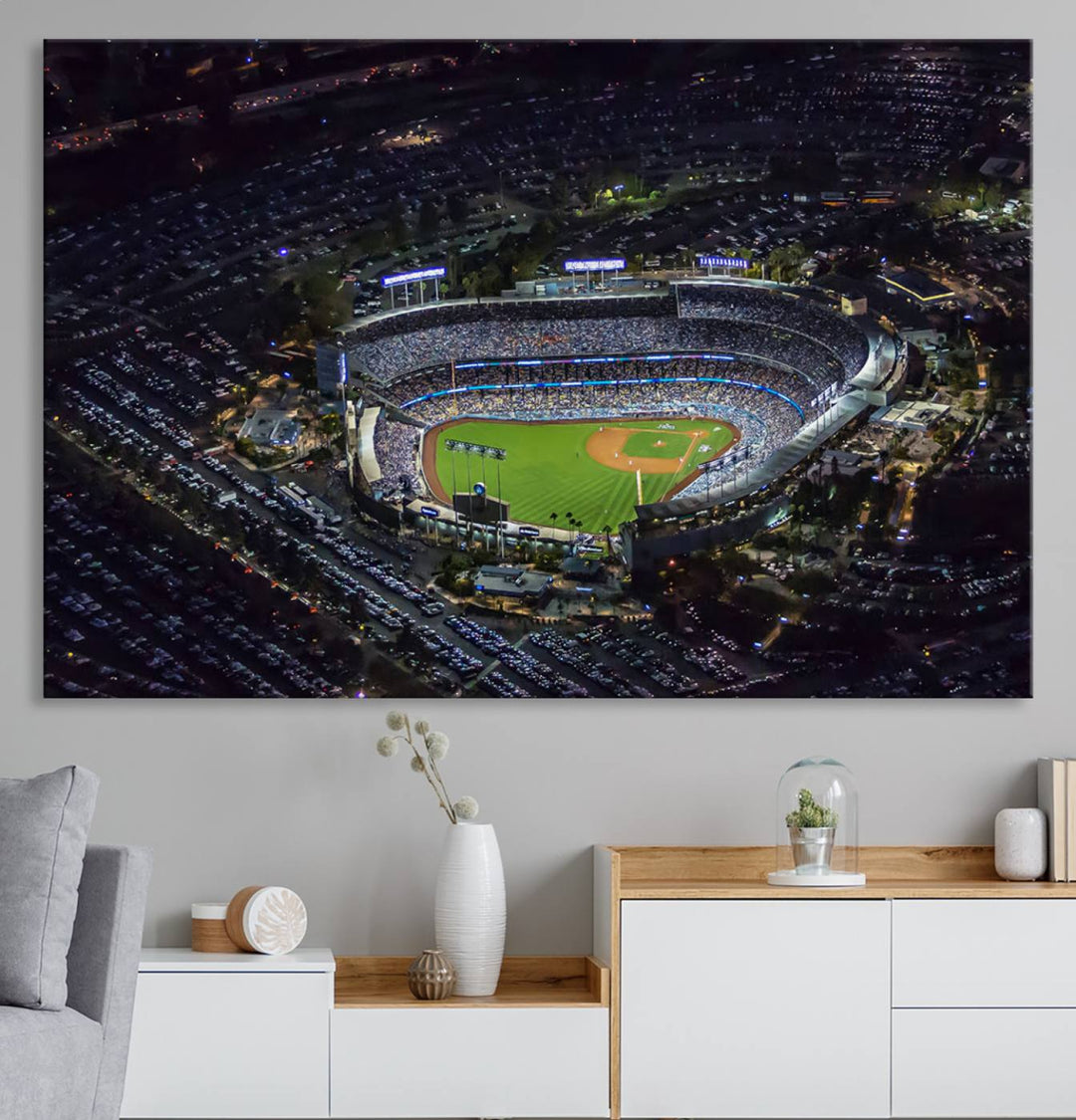 A large Los Angeles Dodgers print of Dodger Stadium at night is displayed near a window.