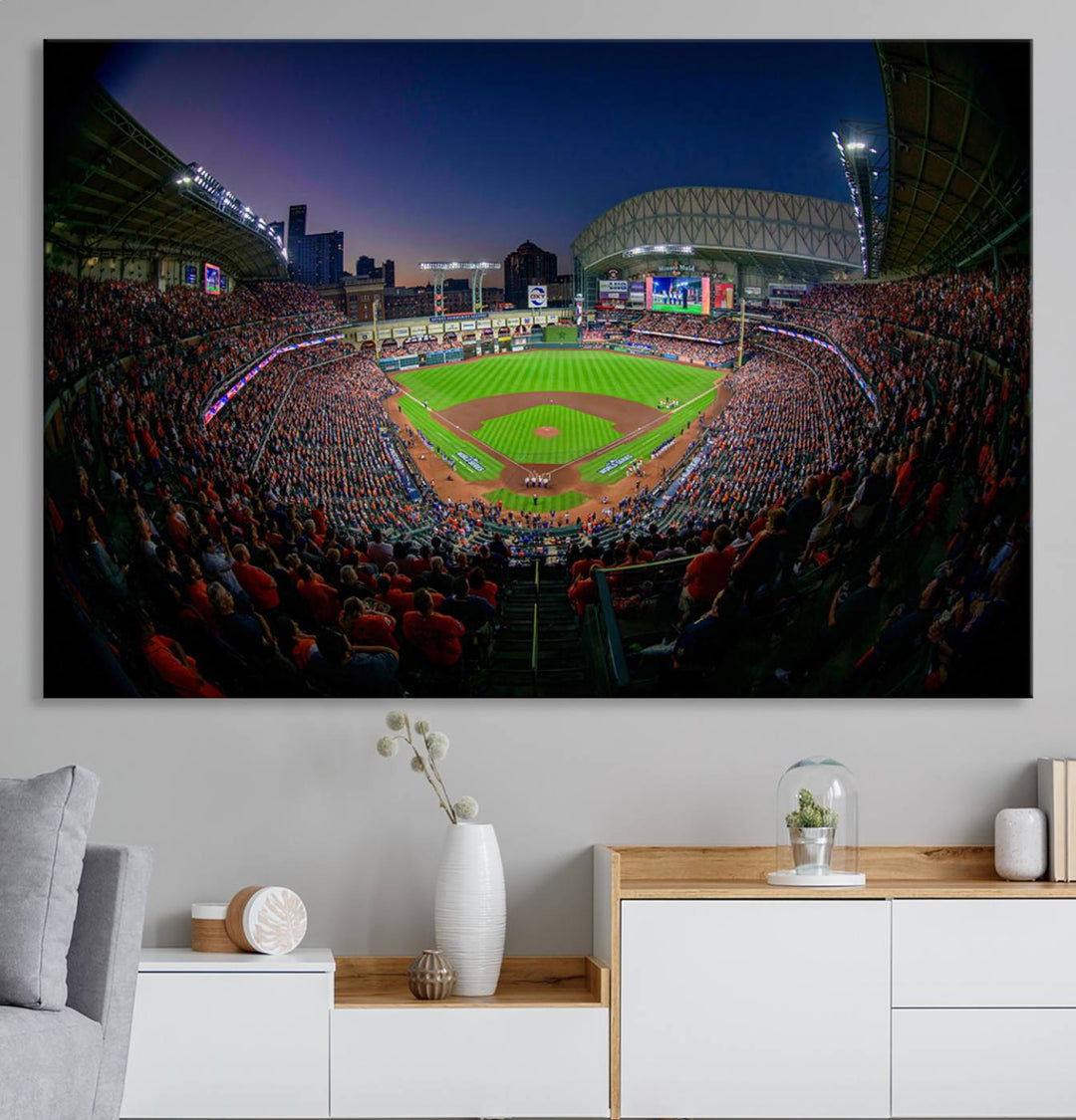 A canvas print of Houston Minute Maid Park at dusk is mounted on the wall.