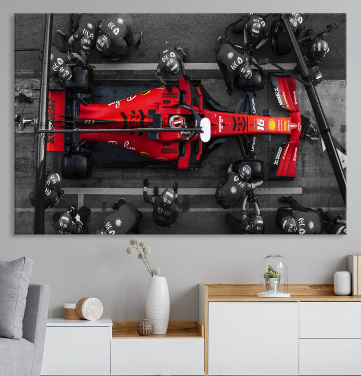 The Ferrari Pit Stop Canvas Wall Art features bold motorsport imagery that captures the precision and speed of Formula 1.