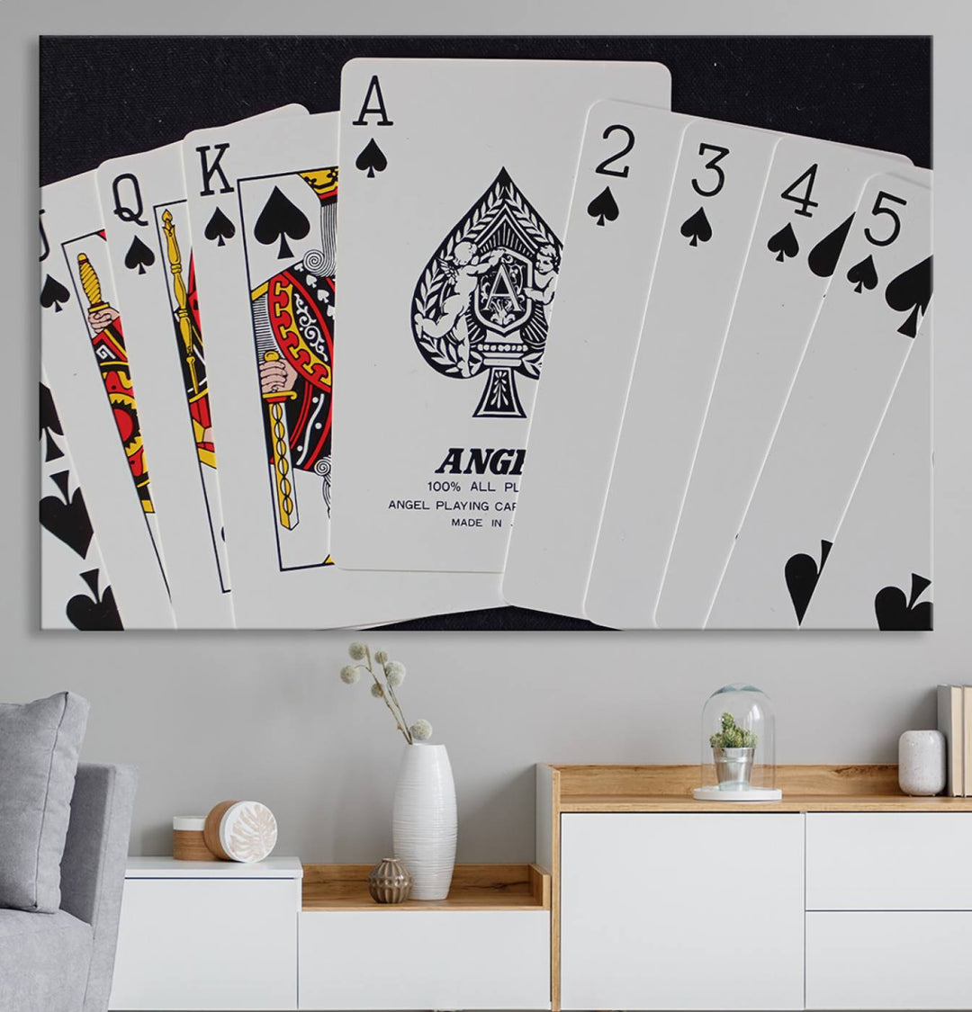 The Poker Wall Art - Playing Cards Canvas Wall Art Print features an Ace of Spades and Royal Flush design. This piece adds a classic charm to any space with its subtle emphasis on the Ace of Spades, making it perfect for game room decor.