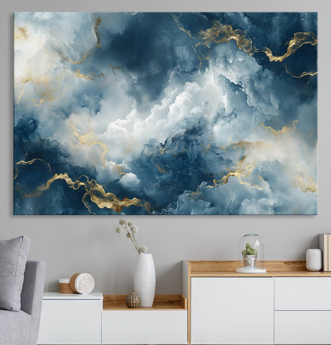 Modern living room featuring the Large Abstract Print - Luxe Blue and Gold Abstract Canvas Wall Art that showcases a bold cloudscape, perfect for modern home decor.