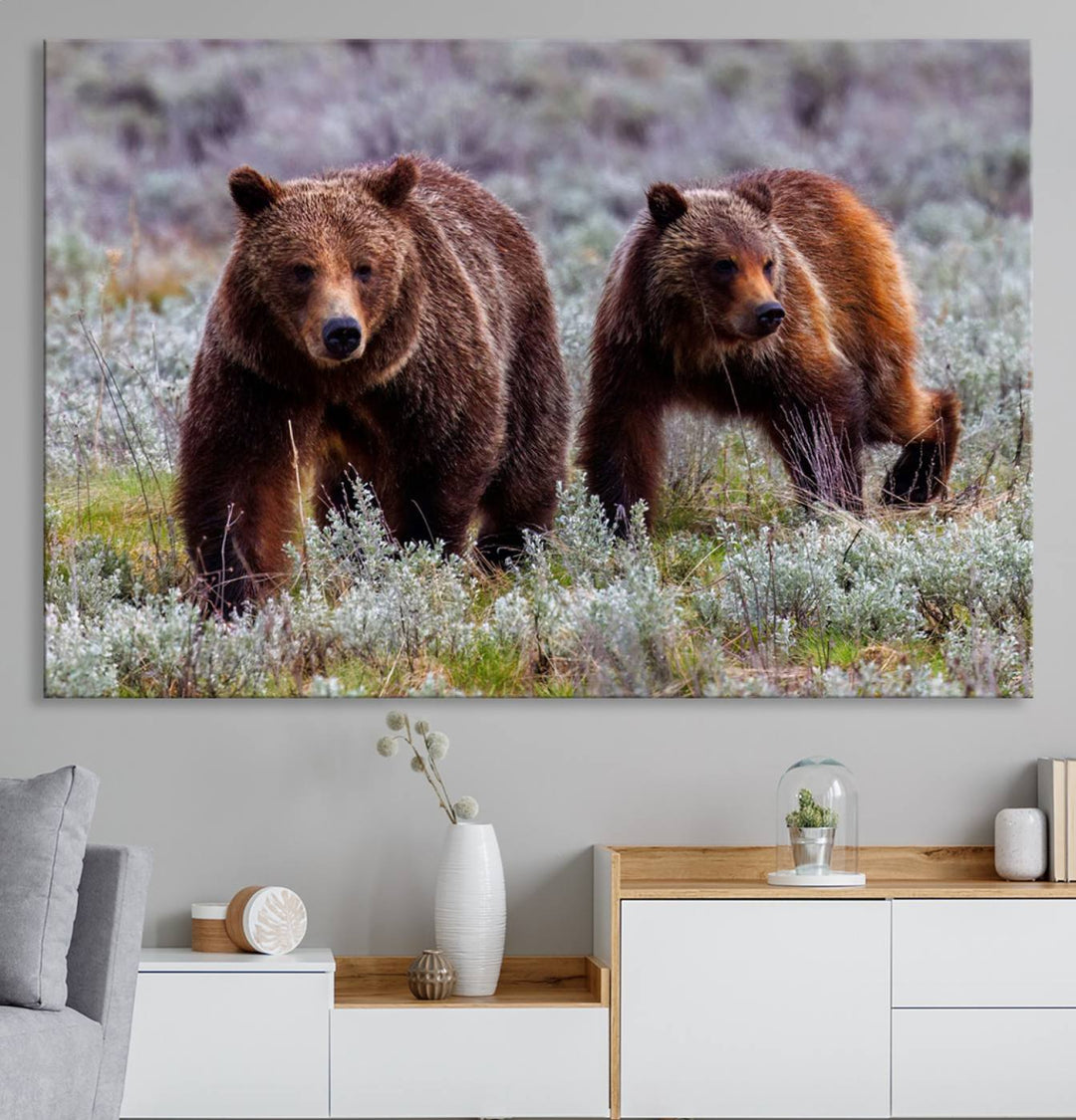 The "Queen of the Tetons" is a stunning canvas art print featuring Grizzly 399 and two bears strolling through a grassy field. Its gallery-quality finish beautifully captures the essence of nature, making it perfect for rustic home decor.