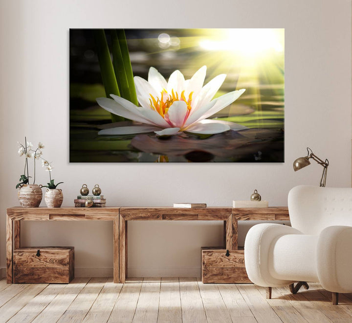 The Lotus Flower Wall Art Canvas Print showcases a white water lily with a yellow center floating gracefully in sunlight.