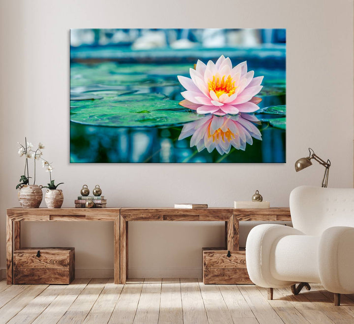 The Lotus Flower Canvas Print showcases a pink water lily with a yellow center gracefully floating on a calm pond.