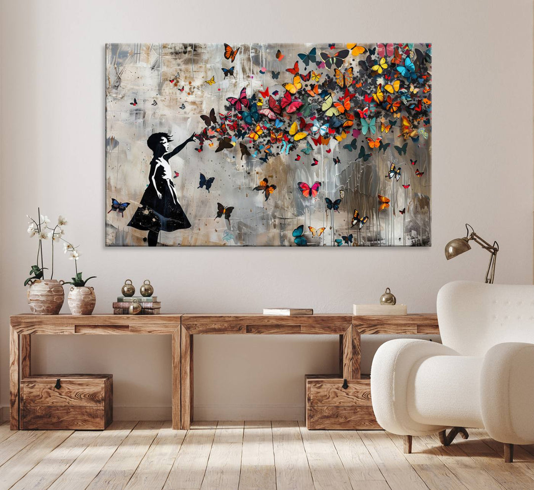 The Banksy Butterfly Girl 3-Piece Modern Graffiti Canvas Wall Art features a silhouette of a girl reaching for butterflies.