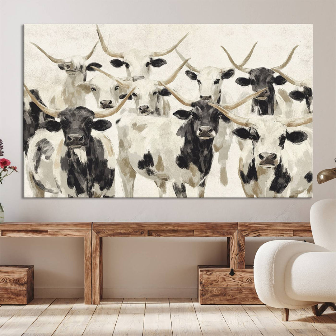 Canvas print titled Longhorn Texas Cow Drawing, depicting longhorn cattle with black and white markings, made in the USA, displayed on the wall.