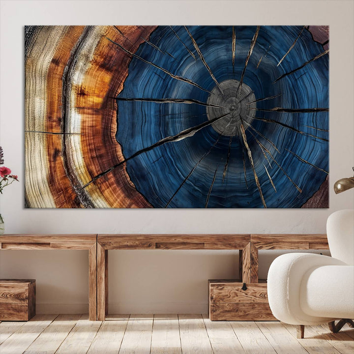 The Abstract Tree Rings Canvas Print features blue, brown, and orange rings that highlight wood grain and natures beauty.