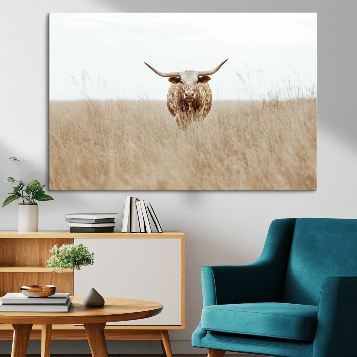 Texas Longhorn bull standing alone in dry grass with neutral tones, ideal for rustic western or cowboy-themed wall decor.