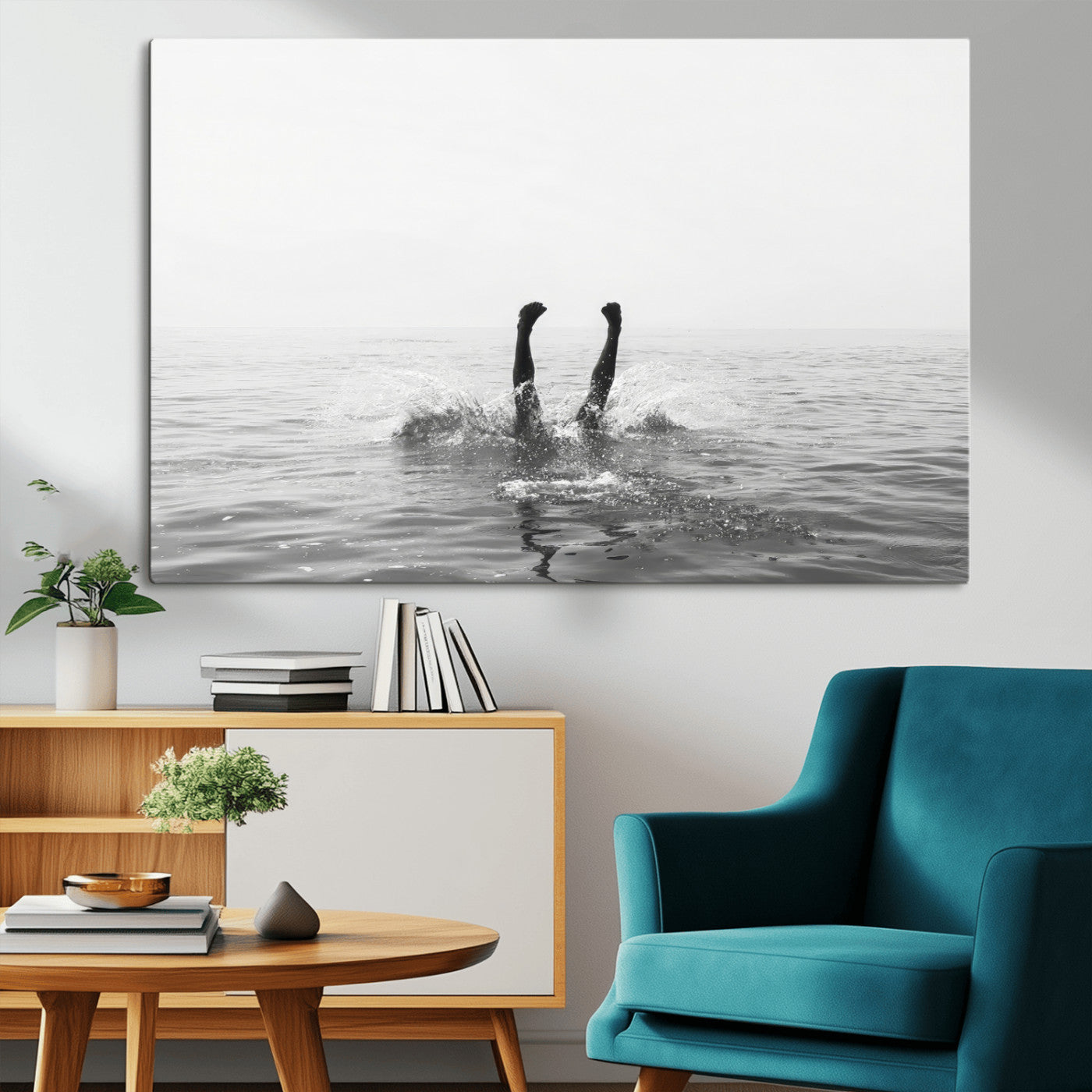 A black and white minimalist water scene capturing a playful splash as a swimmer dives upside down, creating a carefree and artistic aquatic aesthetic.