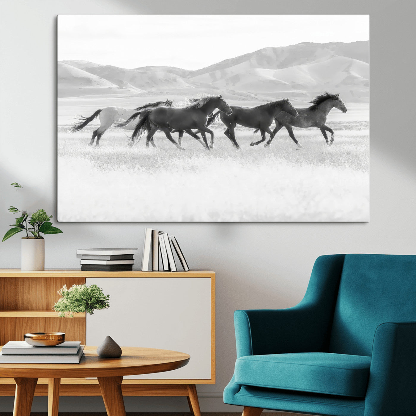 A black and white image of wild horses running freely across an open grassland, capturing the power and beauty of untamed nature in a rustic western setting.