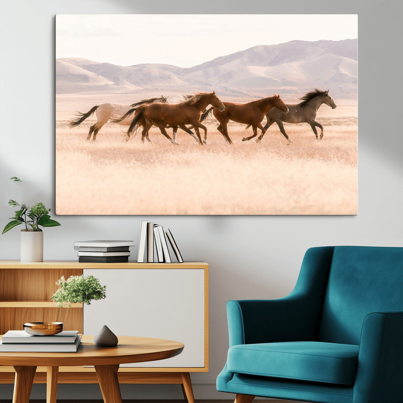 A herd of wild horses galloping through a sunlit desert plain with mountains in the background, perfect for rustic or western-themed wall decor.