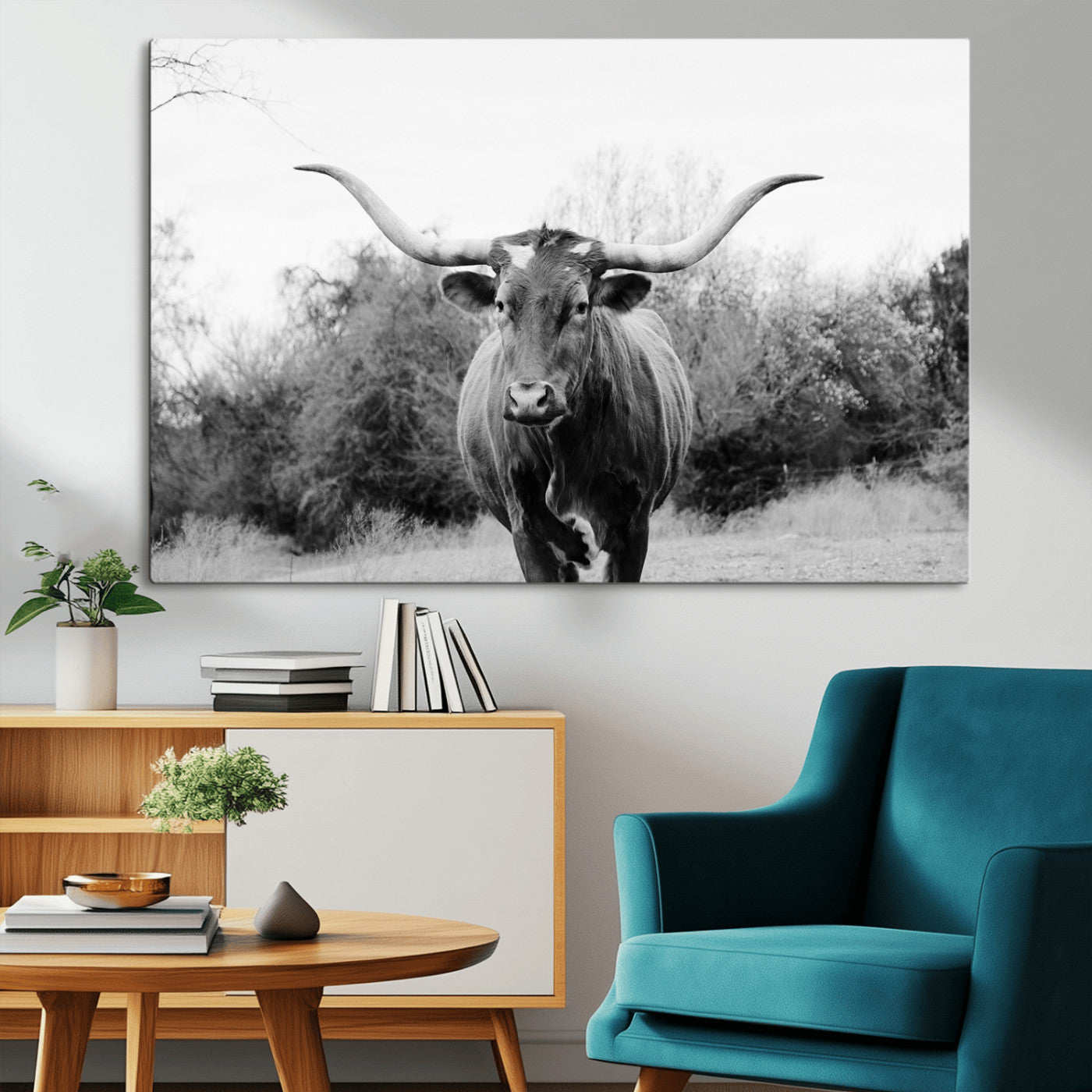 Black and white photo of a Longhorn cow facing camera, ideal for rustic, farmhouse, or western-themed home wall decor.