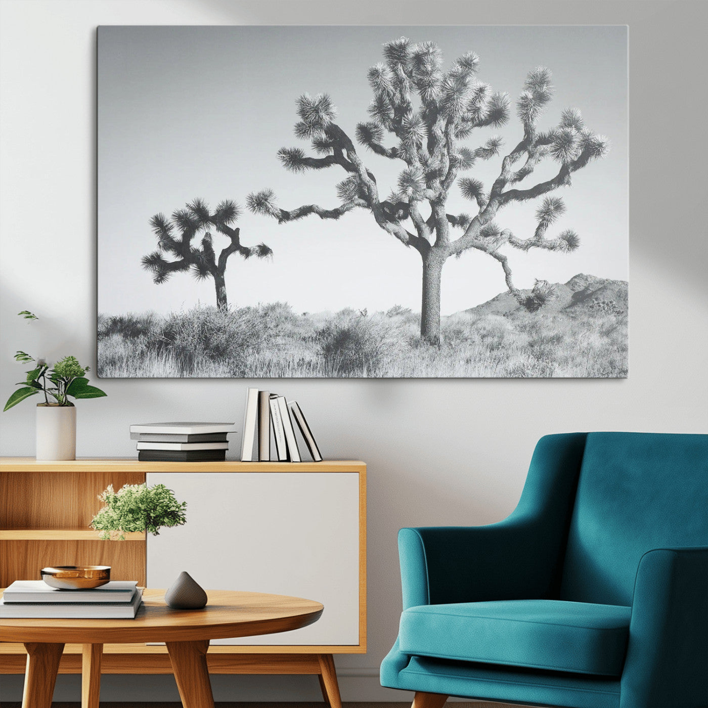 Two Joshua trees in a black and white desert landscape with distant hills, ideal for boho or rustic interior wall styling.