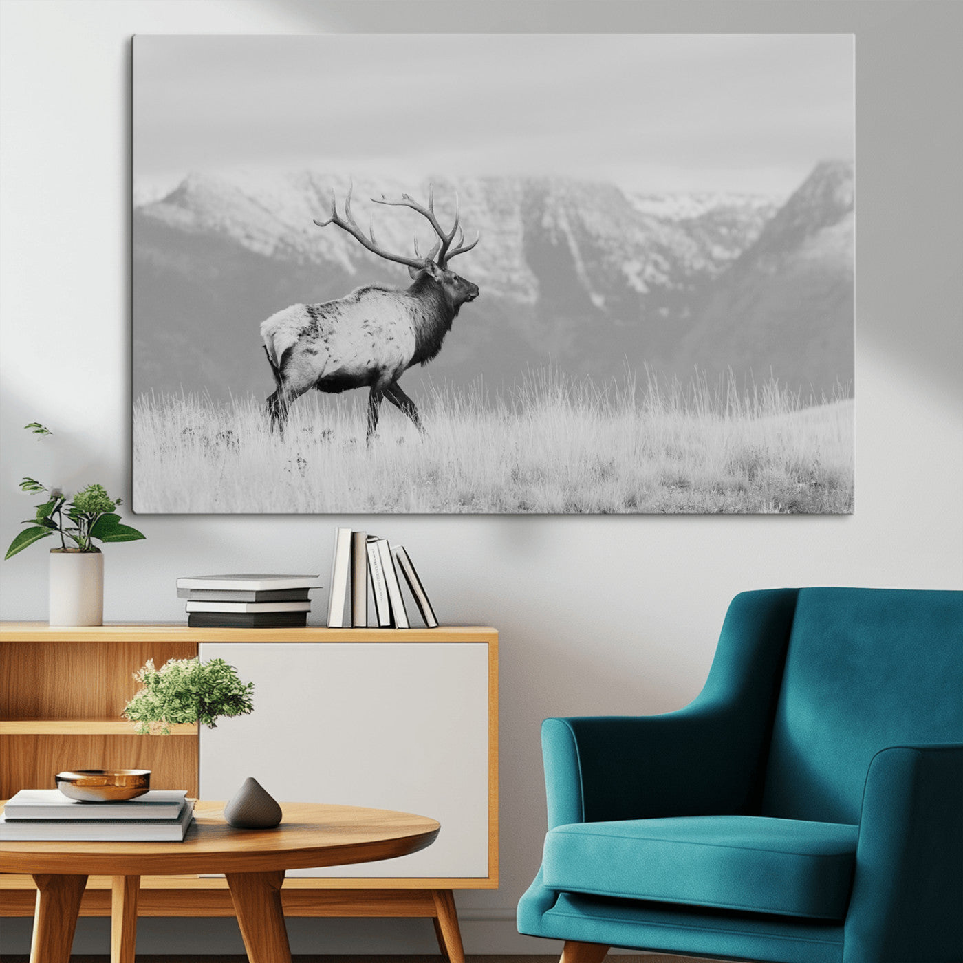 Black and white elk standing in front of snowy mountain range, perfect for rustic lodge or nature-inspired wall decor.