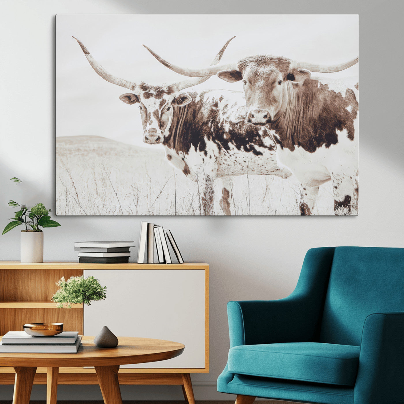 Two longhorn cattle standing in a dry grassy field with neutral tones, creating a rustic and farmhouse-inspired Western aesthetic.