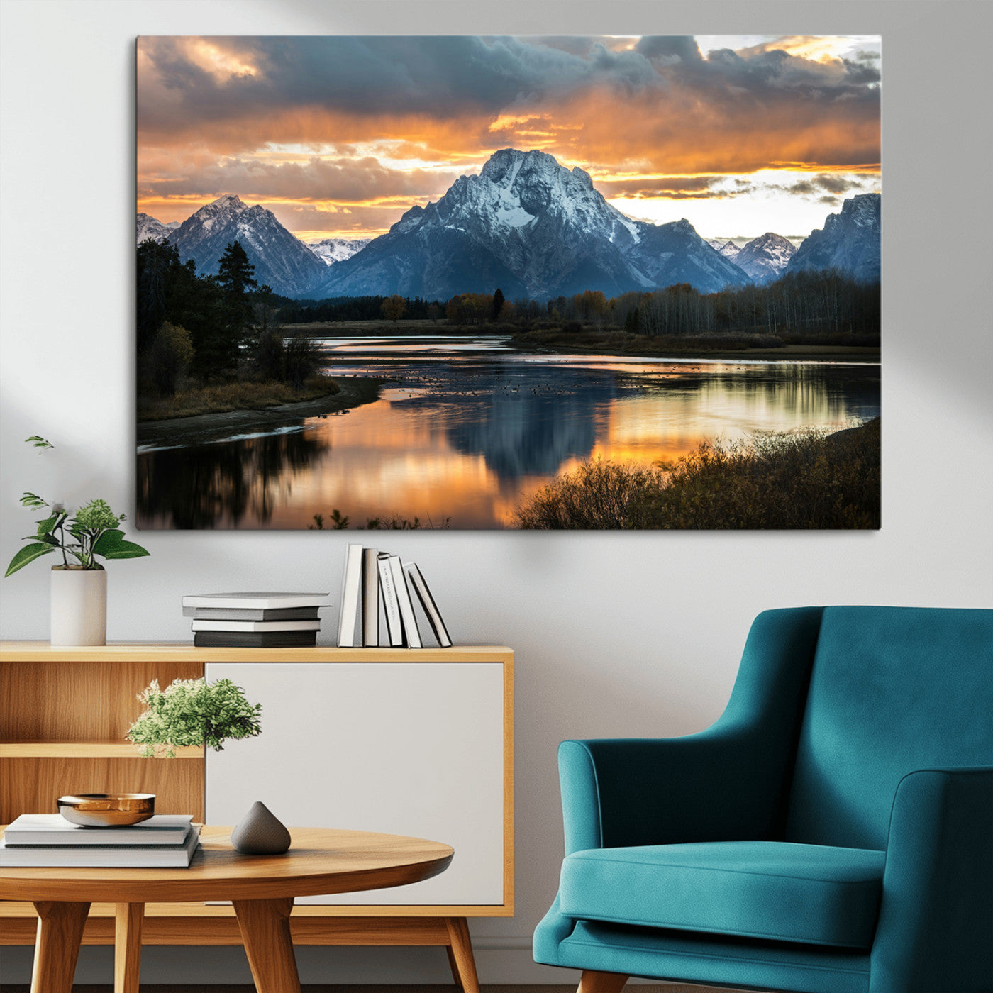Snow-capped mountains reflecting in a calm lake at sunset, with a dramatic golden sky creating a breathtaking wilderness scene.