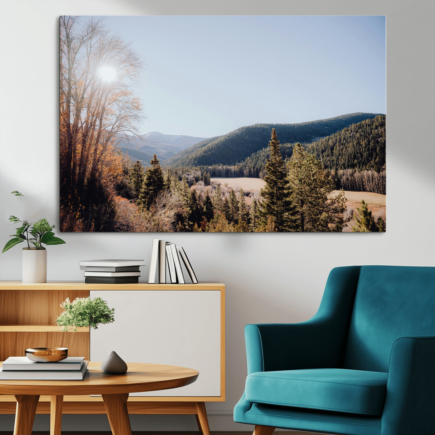 A scenic mountain valley with pine trees and autumn foliage under a clear sky, bathed in golden sunlight, creating a peaceful and rustic landscape.