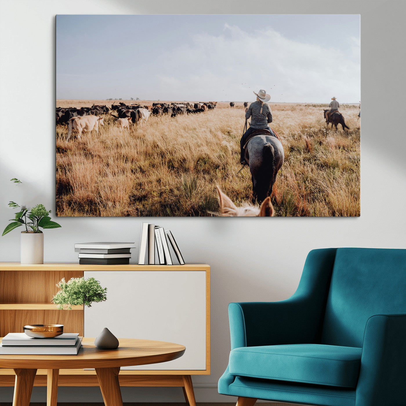 A cowboy and cowgirl on horseback herding cattle through golden grasslands, capturing a rustic and authentic Western ranch lifestyle.