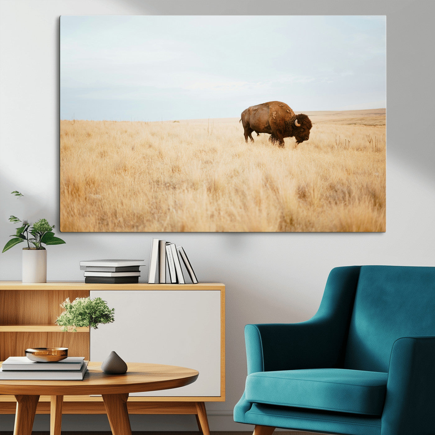 A lone bison standing in a vast golden grassland under a soft blue sky, evoking a rustic and Western aesthetic, ideal for farmhouse decor.