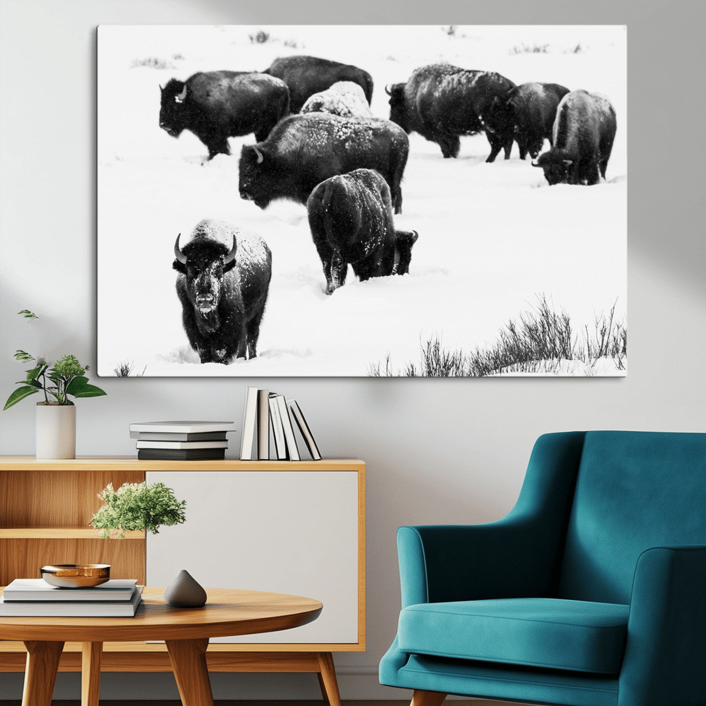 Black and white photograph of a bison herd in a snowy landscape, with snow-covered fur and a rugged wilderness setting, perfect for rustic lodge decor.