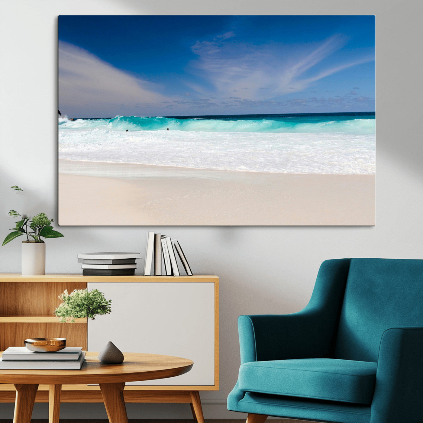 Turquoise waves crash onto a pristine white sand beach under a vivid blue sky with wispy clouds, creating a peaceful and refreshing coastal scene.