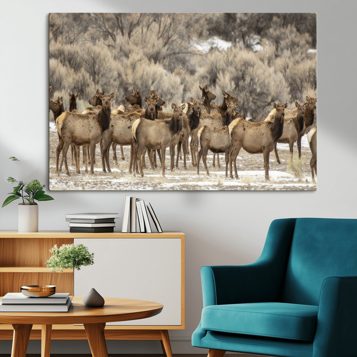 A stunning wall art canvas print featuring a large herd of elk standing together in a natural winter landscape with muted earthy tones and soft background foliage, perfect for rustic or nature-inspired home decor.