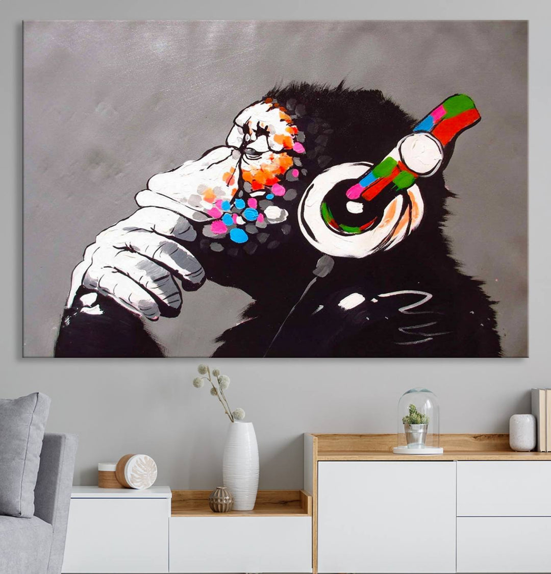 A vibrant triptych, the "DJ Monkey Listening to Music" wall art print, features a Banksy-inspired large canvas adorned with colorful modern pop art. This striking piece elegantly enhances the room with its dynamic and lively depiction.