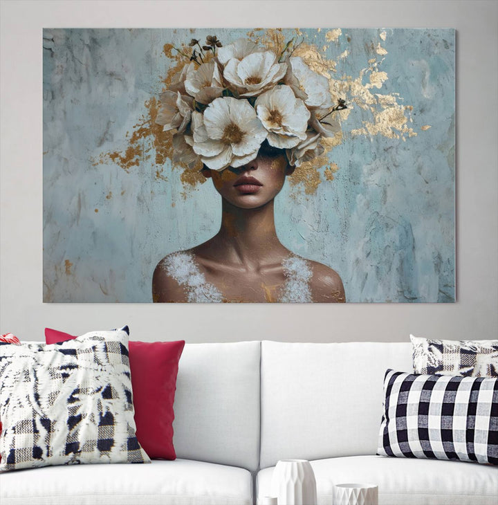 The Golden Petal Silhouette Woman Wall Art Canvas Print, a large 3-panel canvas with a textured gold floral design, serves as a luxurious centerpiece in modern glam settings. The artwork depicts a woman with flowers over her eyes against a textured background and hangs elegantly.