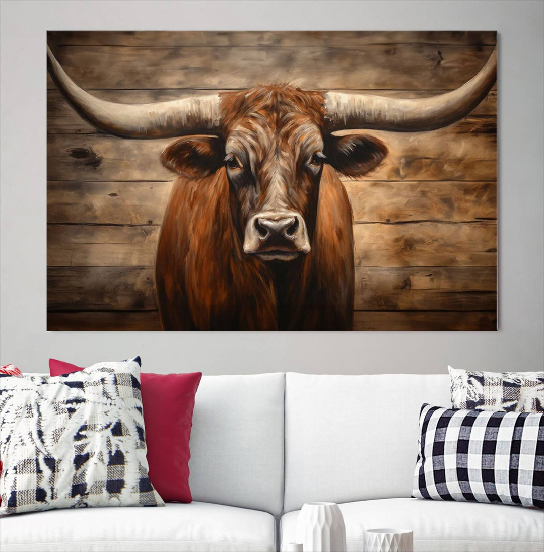 The Longhorn Bull Wall Art, a ready-to-hang canvas print, showcases an image of a brown longhorn cow set against a wooden background, perfect for those looking to enhance their space with rustic farmhouse and western barn decor.