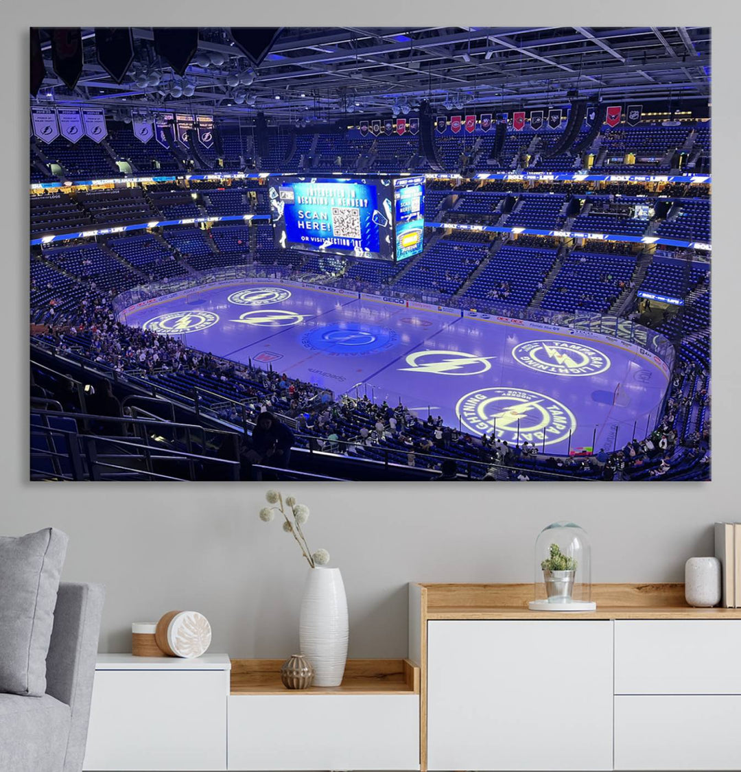 The wall art canvas print at Amalie Arena features team logos on ice, encapsulating the vibrant atmosphere of an NHL hockey stadium.