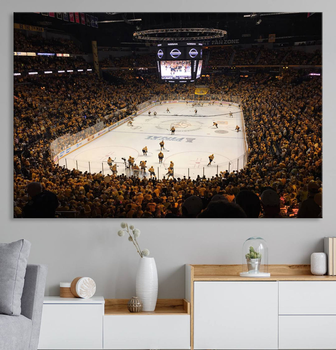 A captivating triptych canvas print, titled "Bridgestone Arena - Nashville Predators Hockey Team Print," adorns the wall. This Nashville wall art canvas print is perfect for Predators fans who appreciate sports-themed decor.